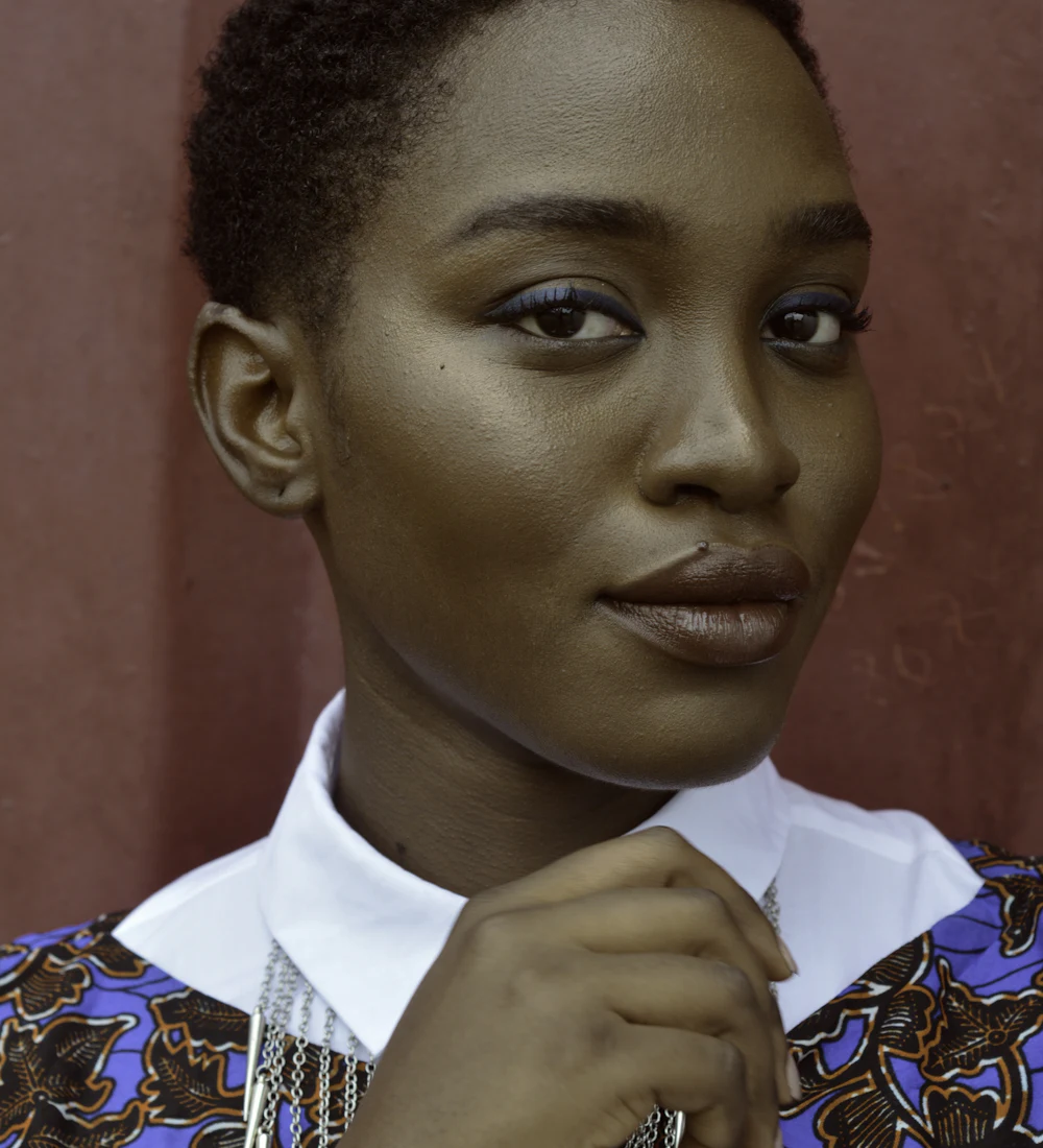 A woman with short hair in a colourful patterned shirt