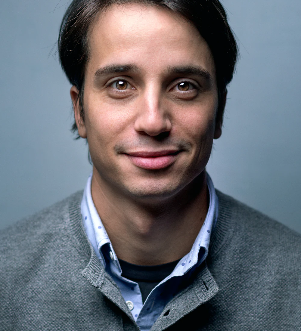 A man in a grey cardigan