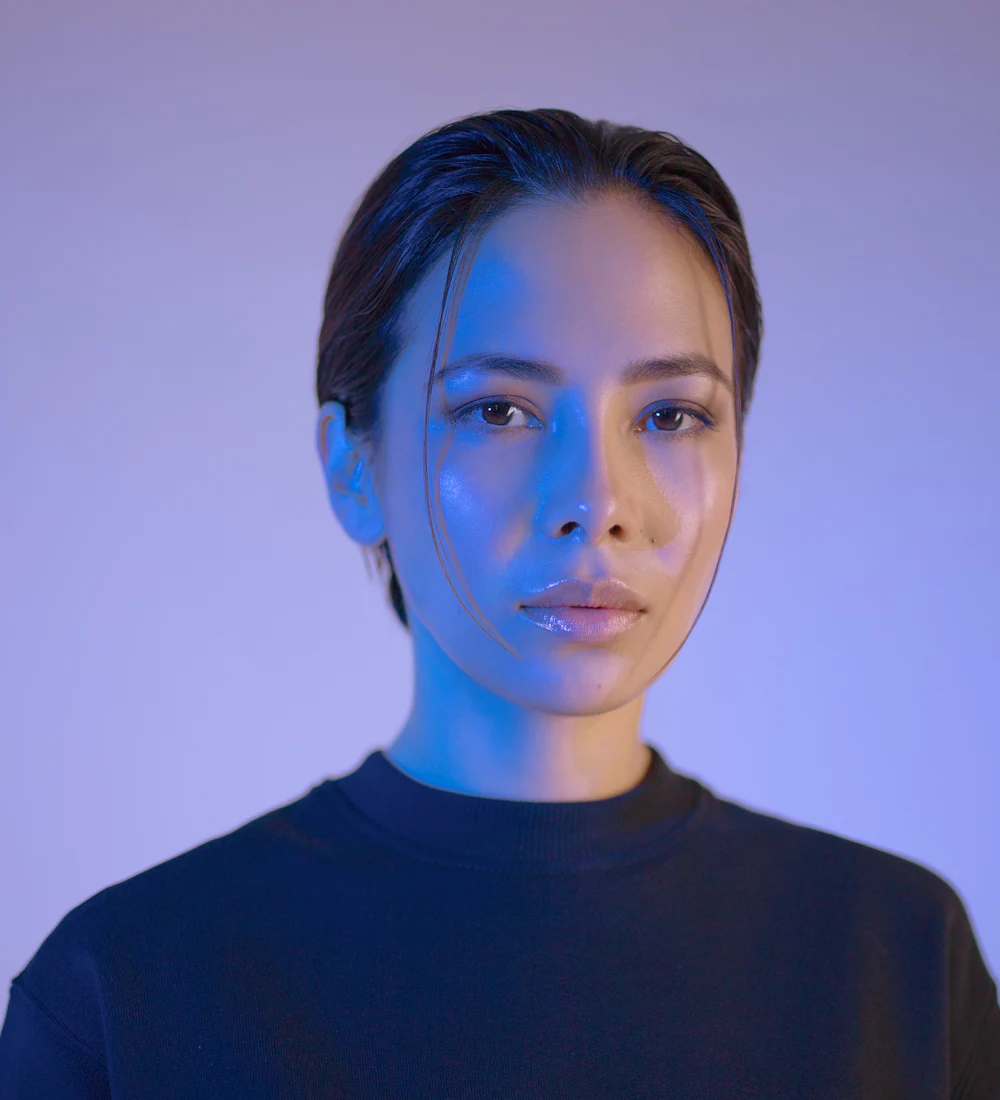 A person in soft blue and purple light