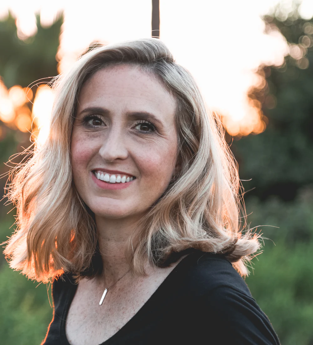 A woman outdoors in warm evening light