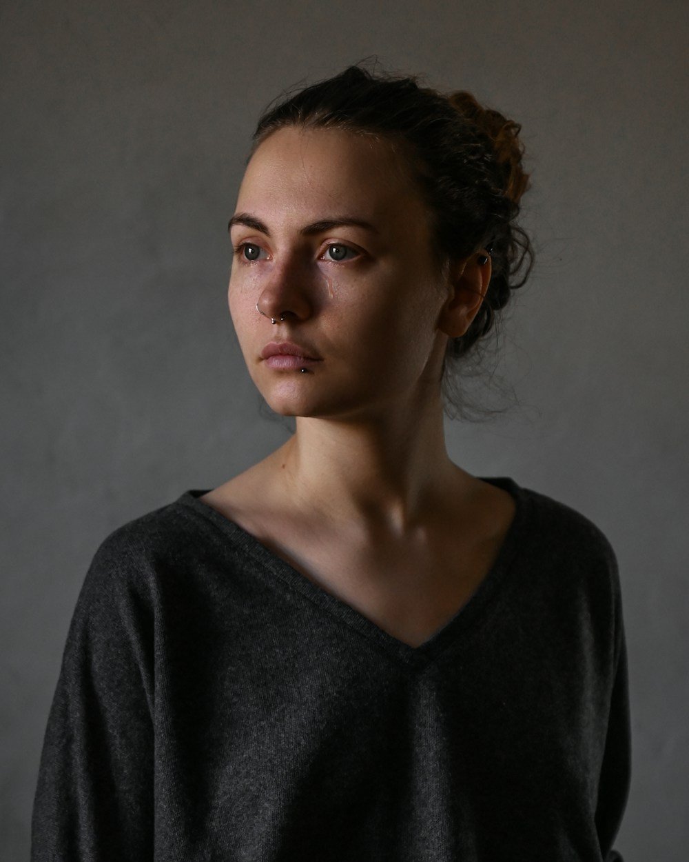 A woman looking thoughtfully to one side